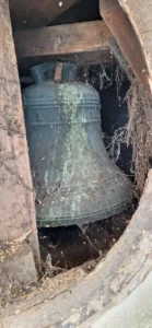 close up photo of the tower with the grill removed revealing the bell inside