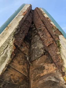 photo close up of rotten wood and rusted metal from the Town Hall clock tower