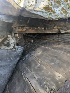 photo showing the leadwork pulled back revealing rotten wood underneath