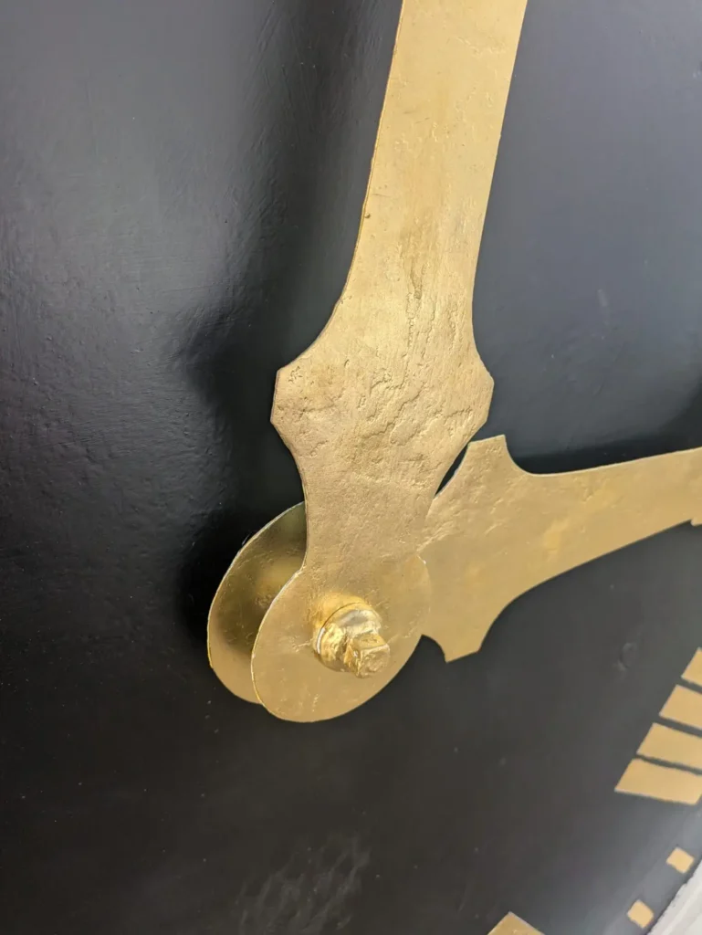 Town Hall clock hands regilded close up